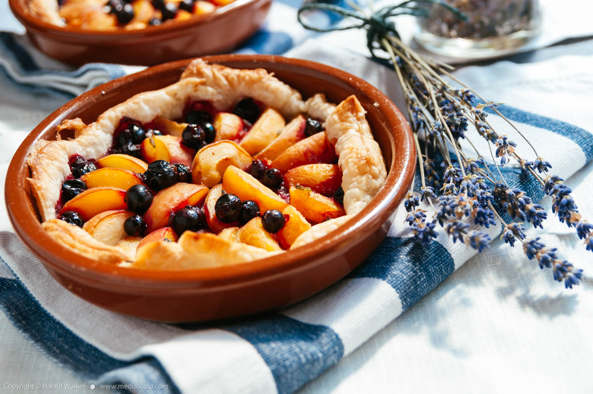 Stock photo of Apricot Almond Tart with Blackcurrants and Lavender Syrup