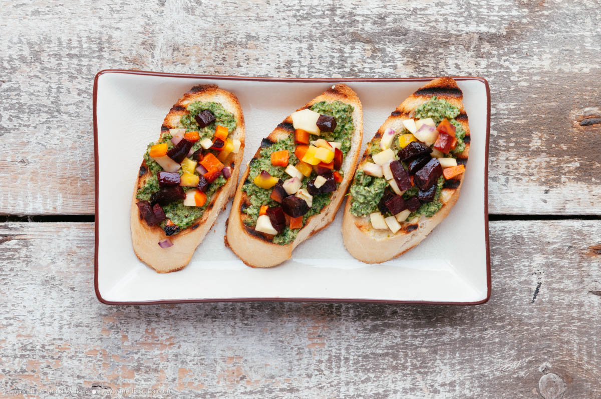 Stock photo of Roasted Fall Veggie Bruschetta with Kale, Sage and Chive Pesto