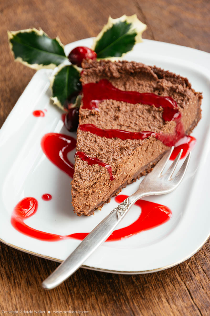 Stock photo of Chocolate Cheesecake with Cranberry Coulis