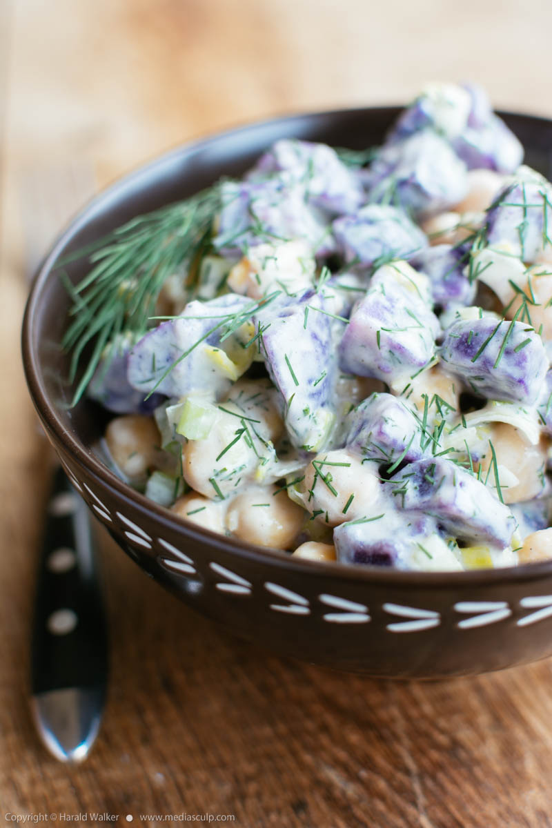 Stock photo of Purple potato salad with chickpeas and dill