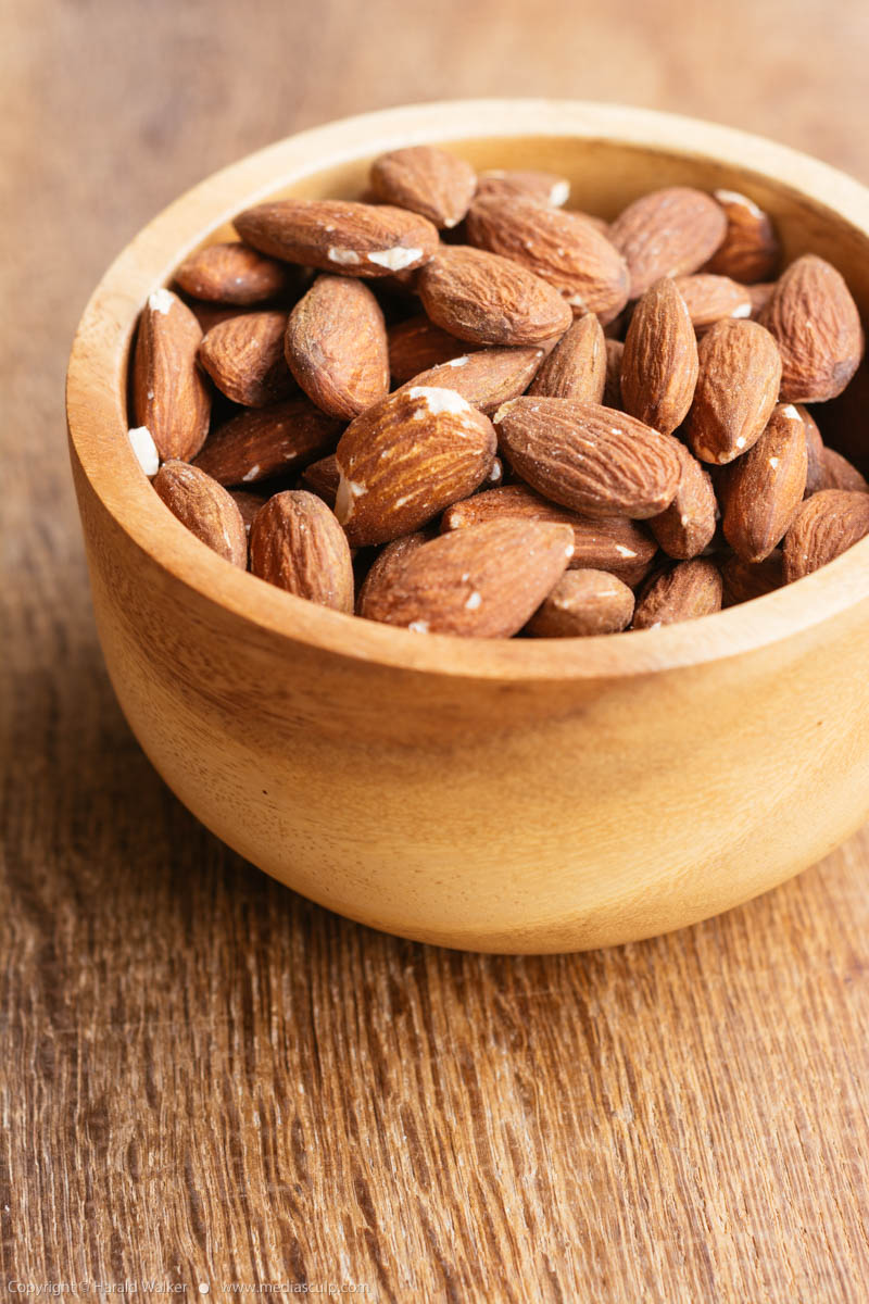 Stock photo of Almonds in a wooden bowl