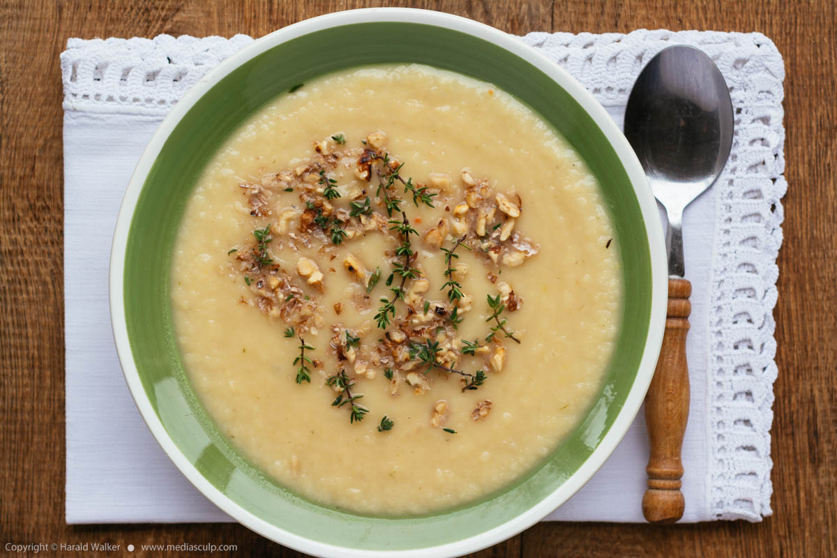 Stock photo of Apple Parsnip Soup with Thyme Walnut Garnish
