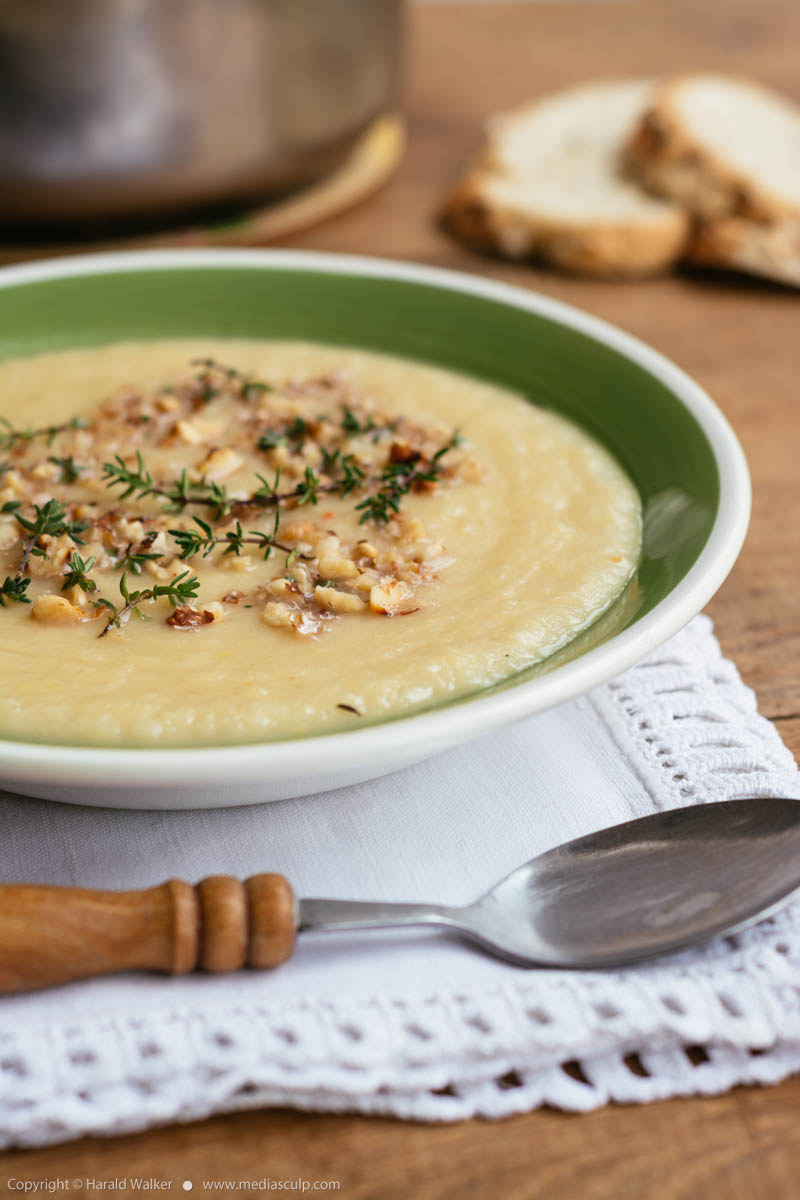 Stock photo of Apple Parsnip Soup with Thyme Walnut Garnish