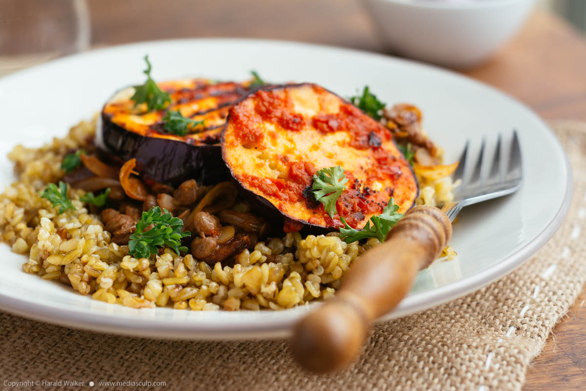 Stock photo of Middle-eastern freekeh lentil and harrisa eggplant