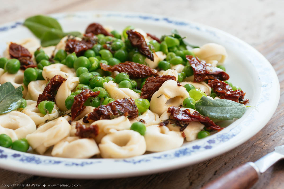 Stock photo of Tortellini with Fresh Garden Peas and Sun-dried Tomatoes