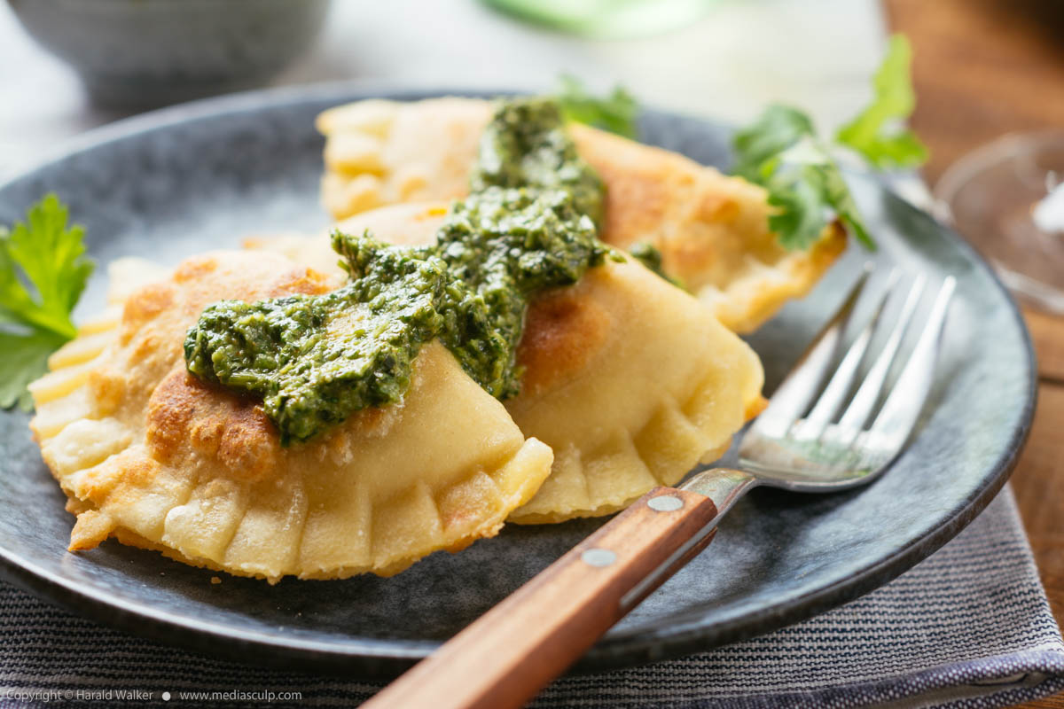 Stock photo of Squash pot-stickers with a cilantro sauce