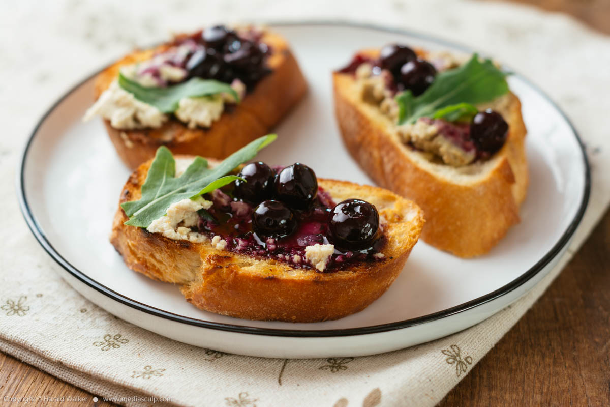 Stock photo of Bruschetta with Vegan Spreads and Pickled Blueberry Sauce