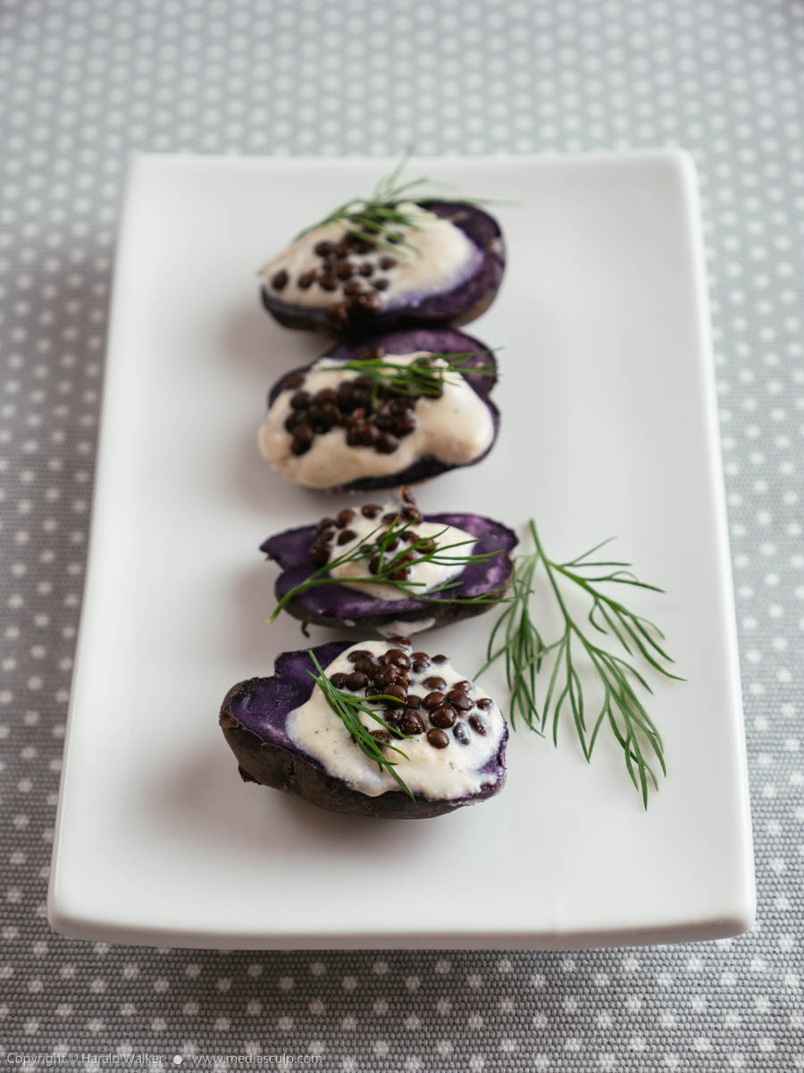 Stock photo of Purple Potatoes with Vegan Feta Spread and Beluga Lentils