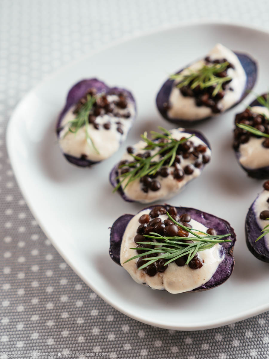 Stock photo of Purple Potatoes with Vegan Feta Spread and Beluga Lentils