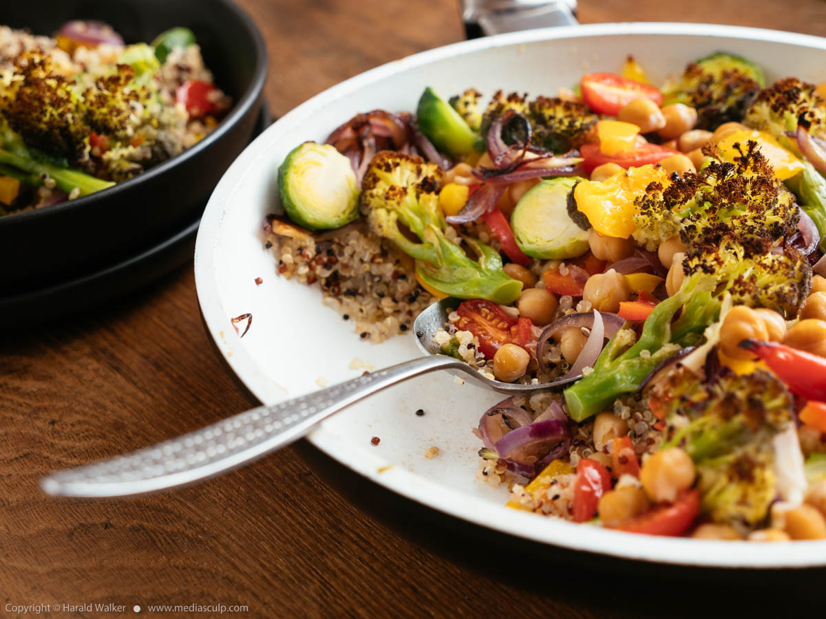 Stock photo of Roasted Purple Sprouting Broccoli, Brussels Sprouts and Peppers on Quinoa
