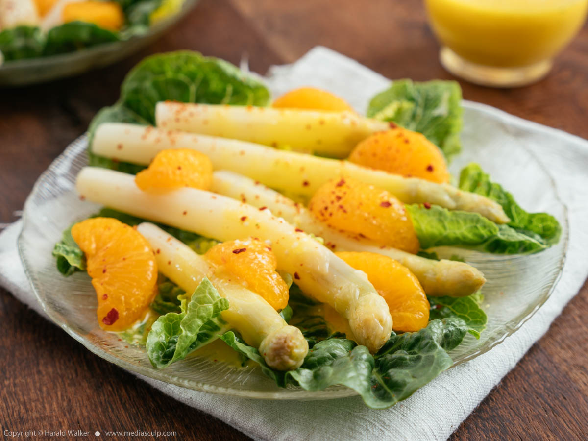 Stock photo of White Asparagus on Lettuce with Orange Dressing