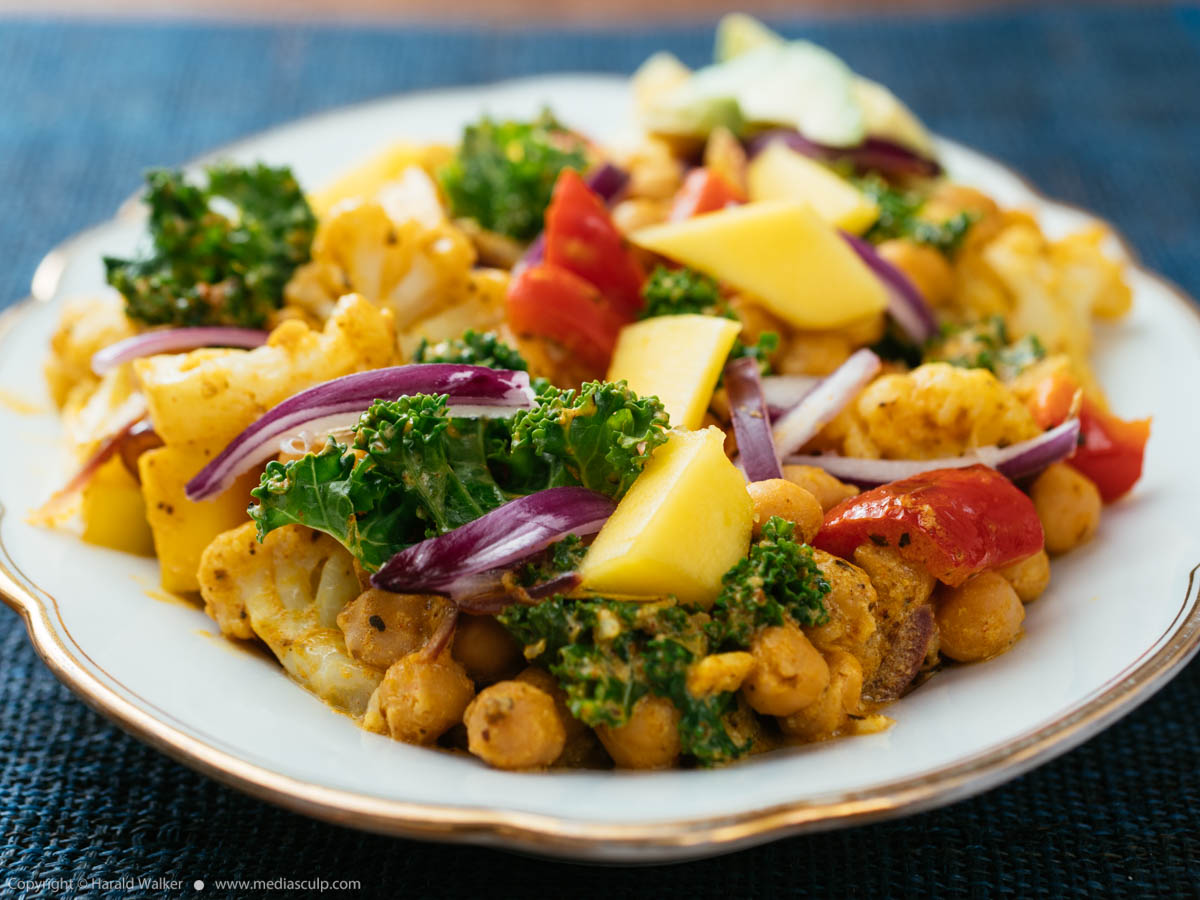 Stock photo of Chickpea, Cauliflower Curry with Kale and Mango