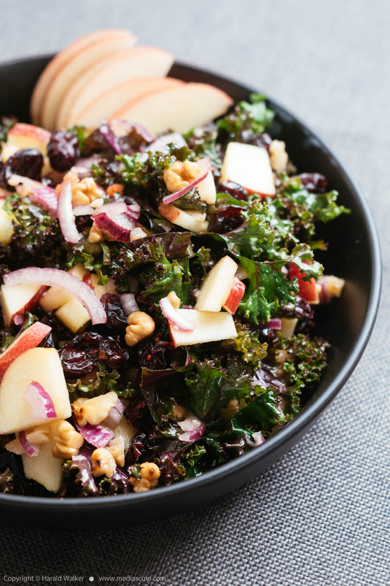 Stock photo of Kale Salad with Apples, Walnuts, Cranberries and Red Onions