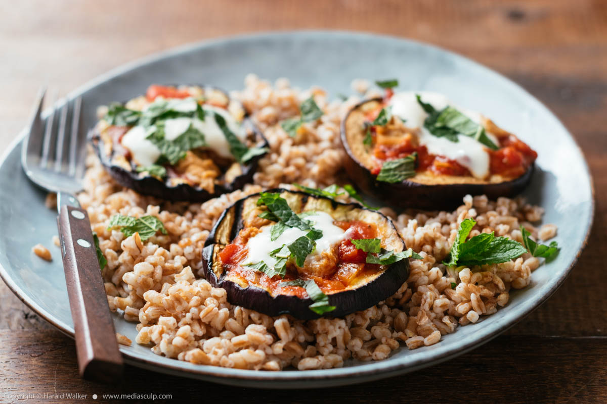 Stock photo of Grilled Eggplant on Farro with Tomato Sauce, Yogurt and Mint
