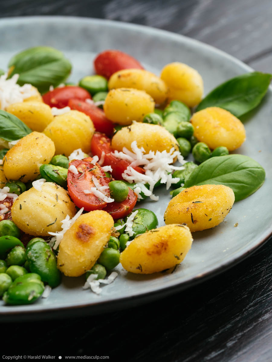 Stock photo of Gnocchi with fava beans, peas and tomatoes
