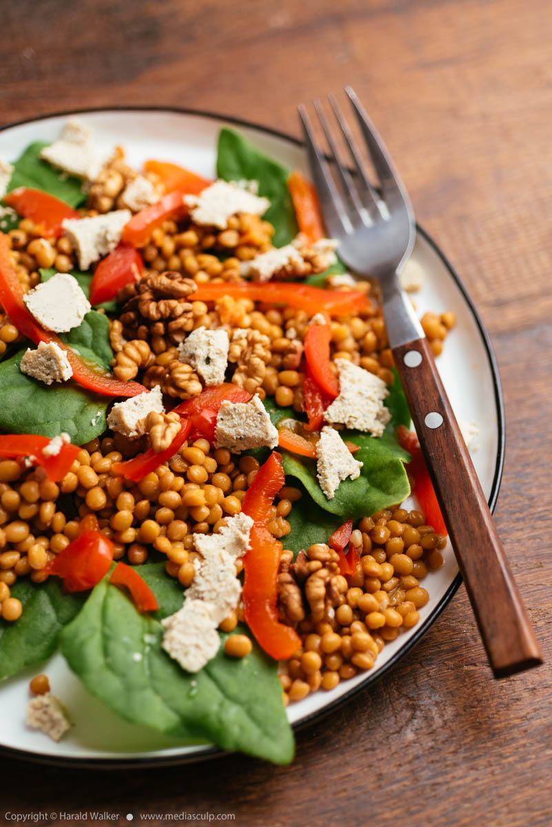 Stock photo of Spinach and Lentil Salad with Roasted Peppers, Walnuts and Vegan Feta