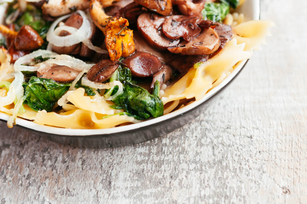 Stock photo of Mixed Mushrooms and Spinach on Pasta