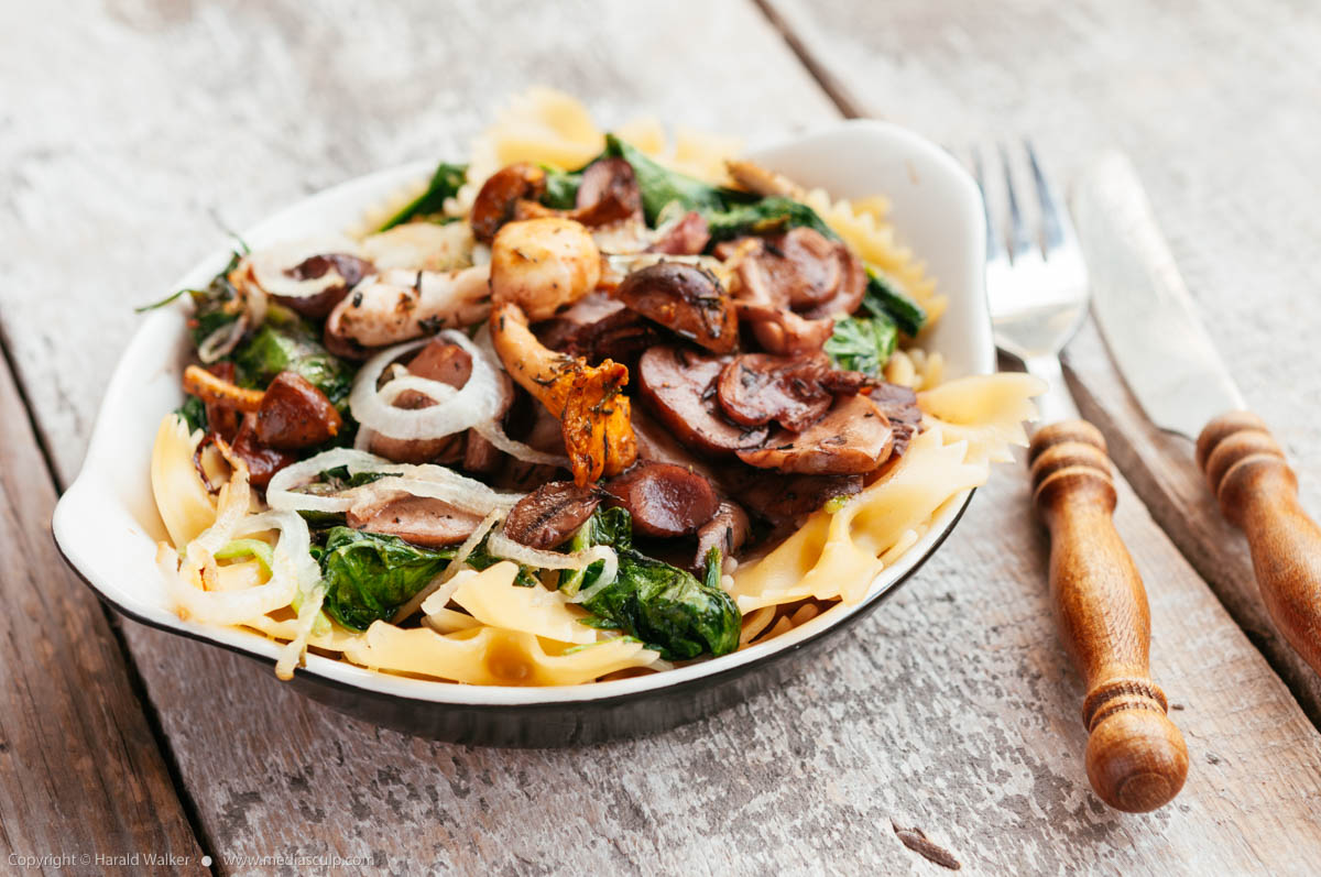 Stock photo of Mixed Mushrooms and Spinach on Pasta