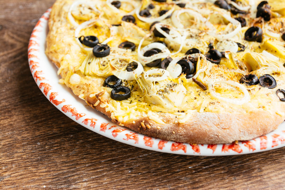 Stock photo of Artichoke and black olives pizza