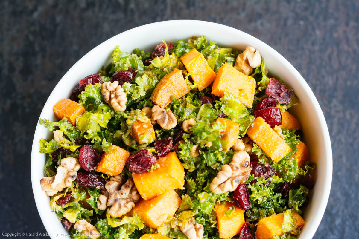Stock photo of Kale Salad with Roasted Sweet Potatoes, Cranberries and Walnuts