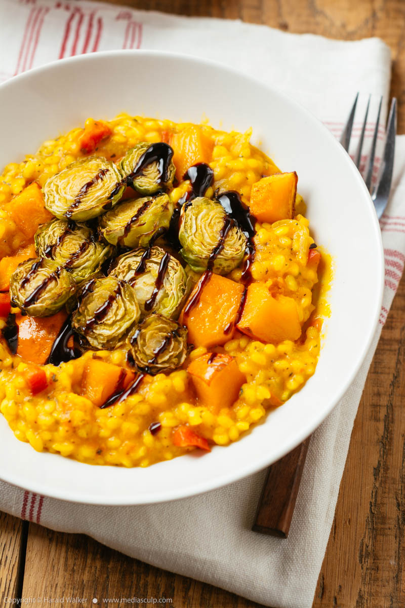 Stock photo of Squash Risotto with Roasted Brussels Sprouts and Balsamic Vinegar Reduction