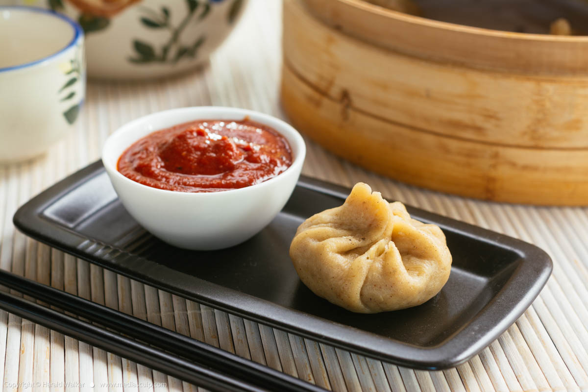 Stock photo of Chinese Dumplings with a Spicy Tomato Sauce