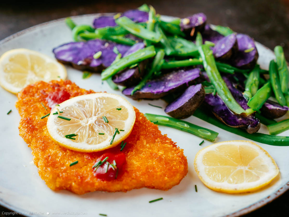 Stock photo of Purple Potatoes with Green Beans and Vegan Schnitzel