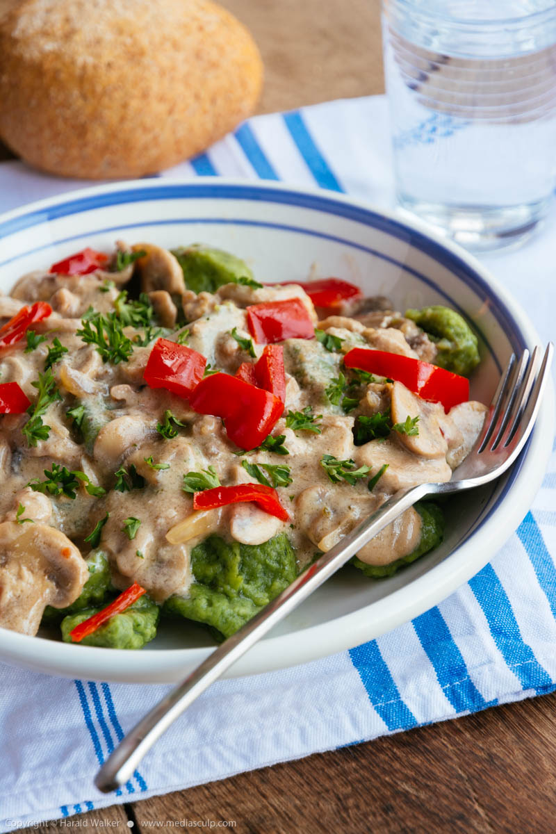 Stock photo of Spinach gnocchi with mushrooms and bell pepper