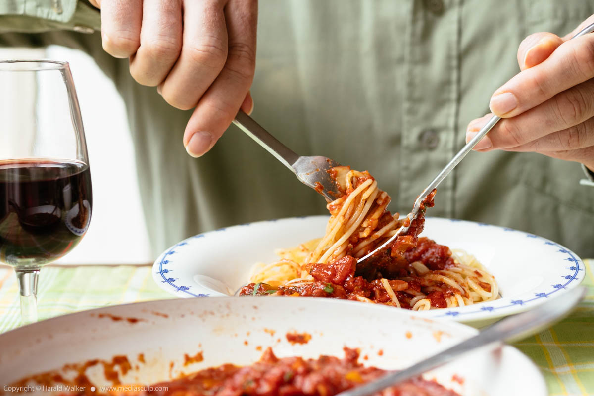 Stock photo of Man eating spaghetti