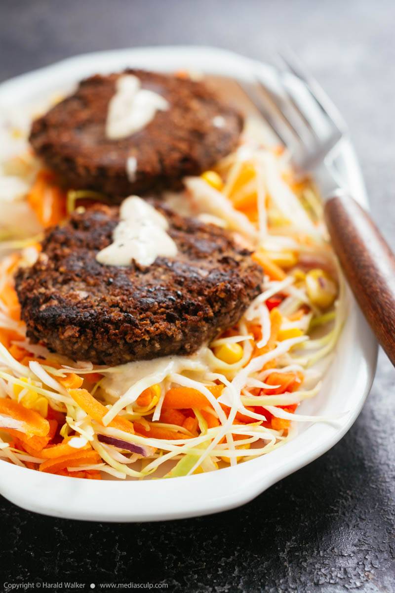 Stock photo of Black Bean Patties on Mexican Coleslaw