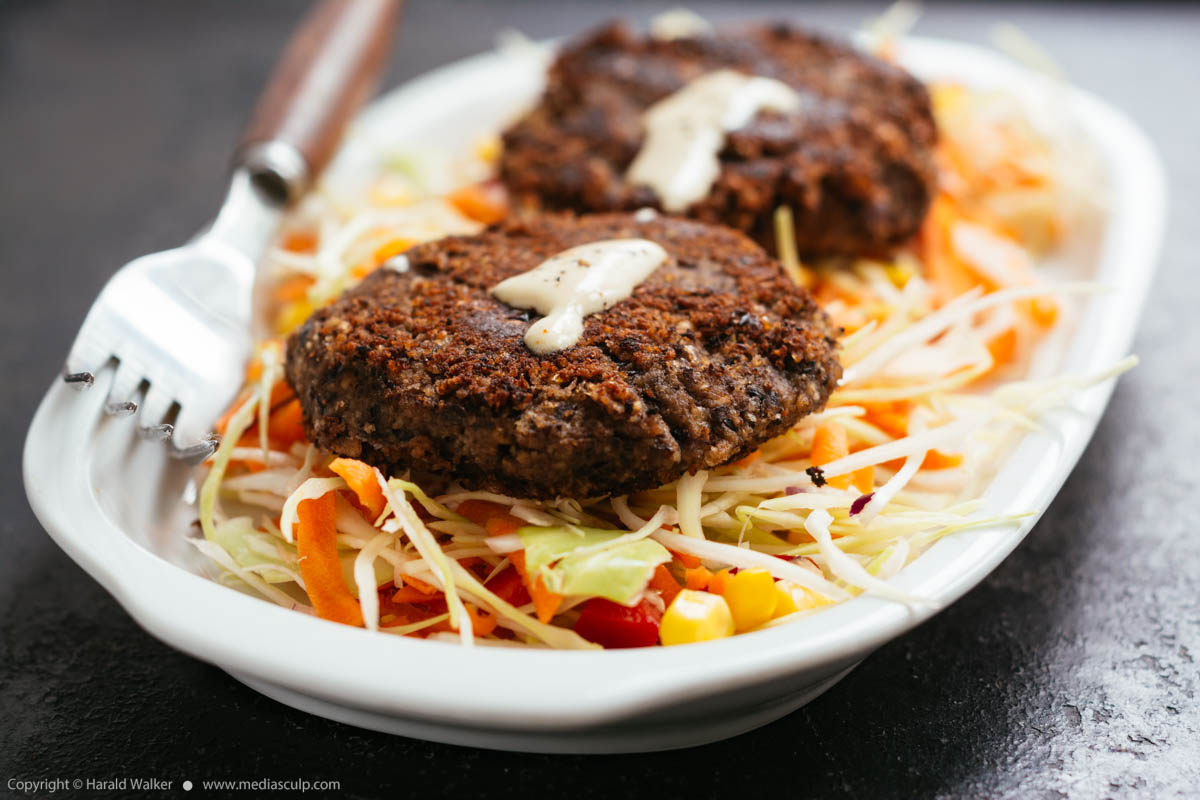 Stock photo of Black Bean Patties on Mexican Coleslaw
