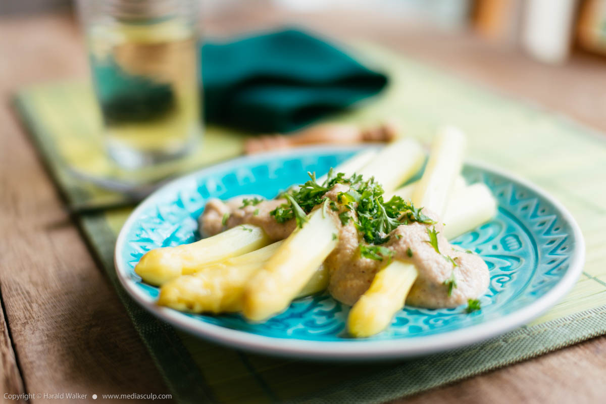 Stock photo of White asparagus with cashew cream sauce